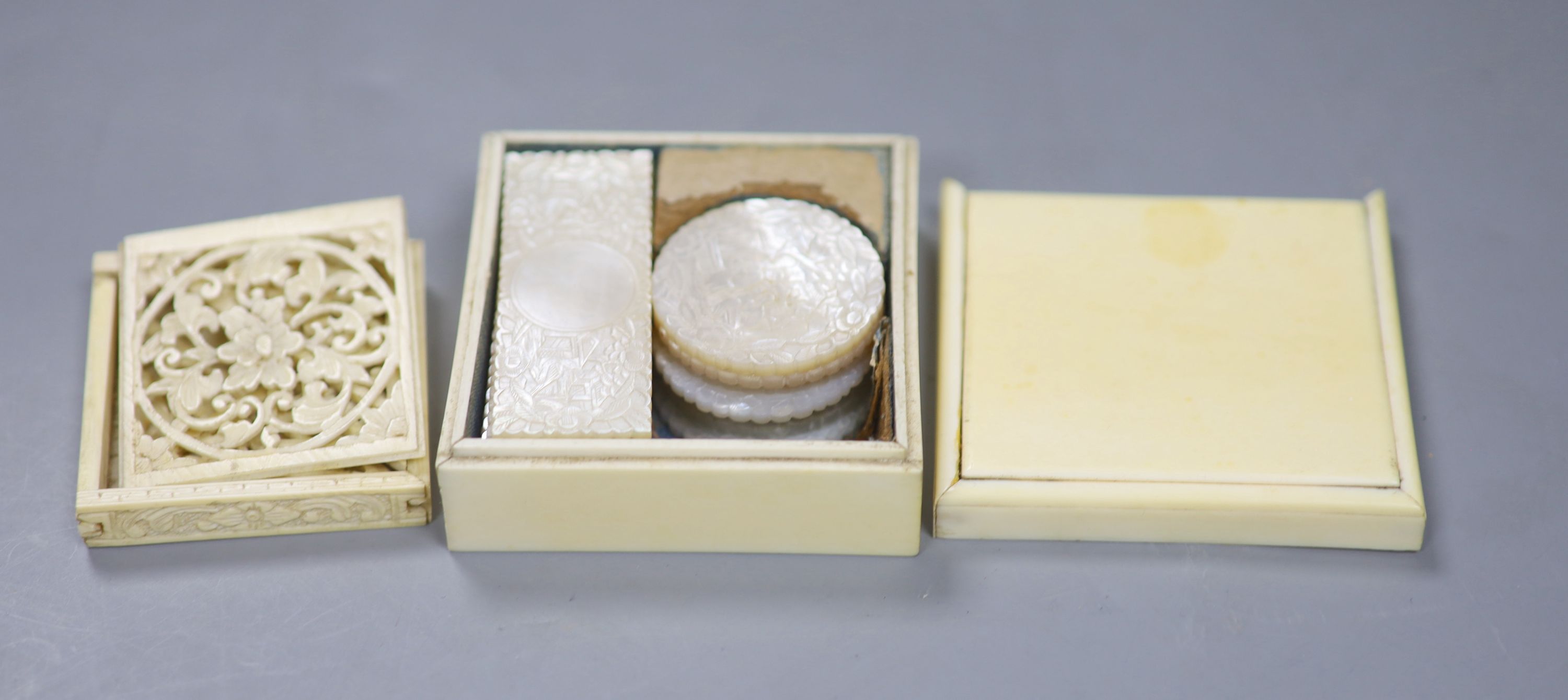 A 19th century ivory box containing a collection of fourteen Chinese carved mother-of-pearl gaming tokens, together with a 19th century